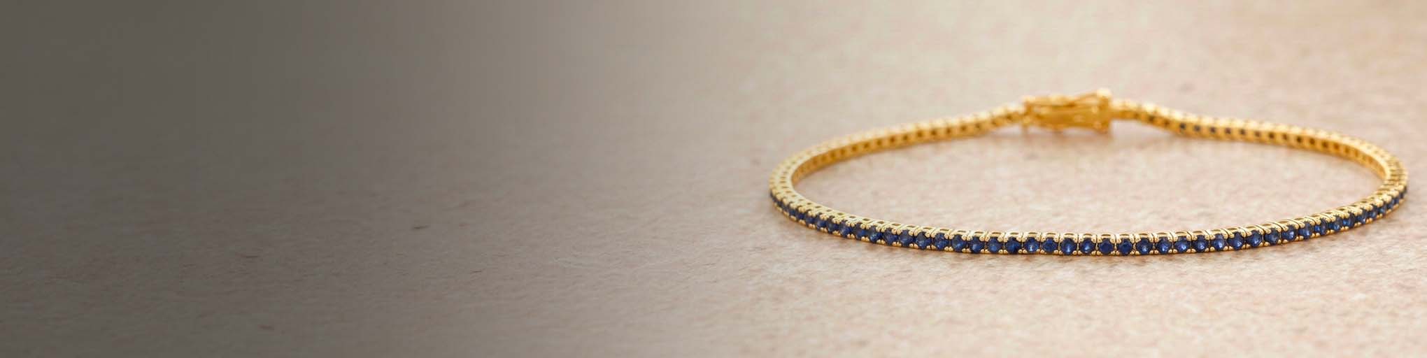 Blue sapphire tennis bracelet claw set yellow gold 18K fine jewellery luxury