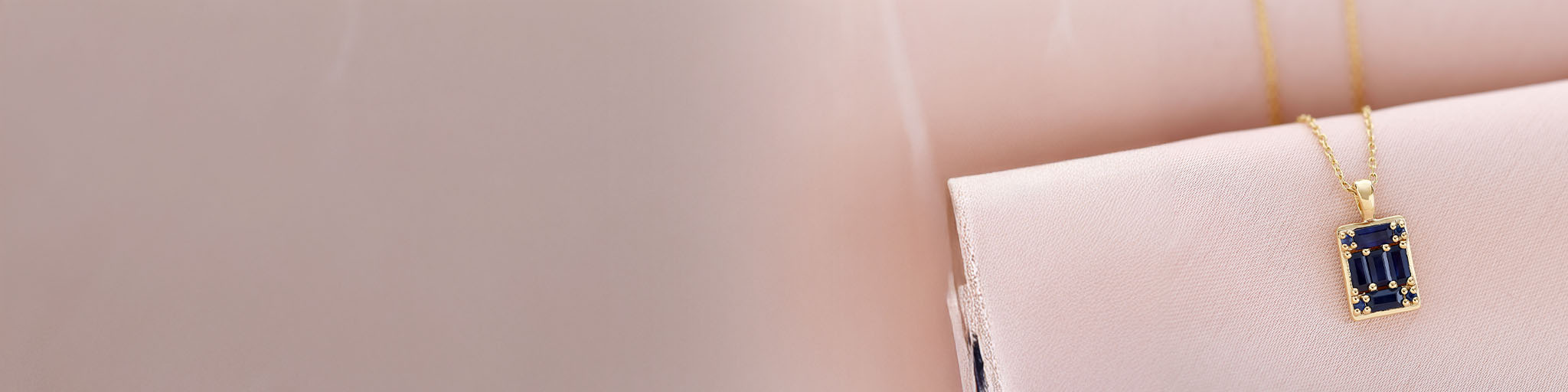 Geometric yellow gold necklace with rectangular blue sapphires, modern jewellery on delicate chain