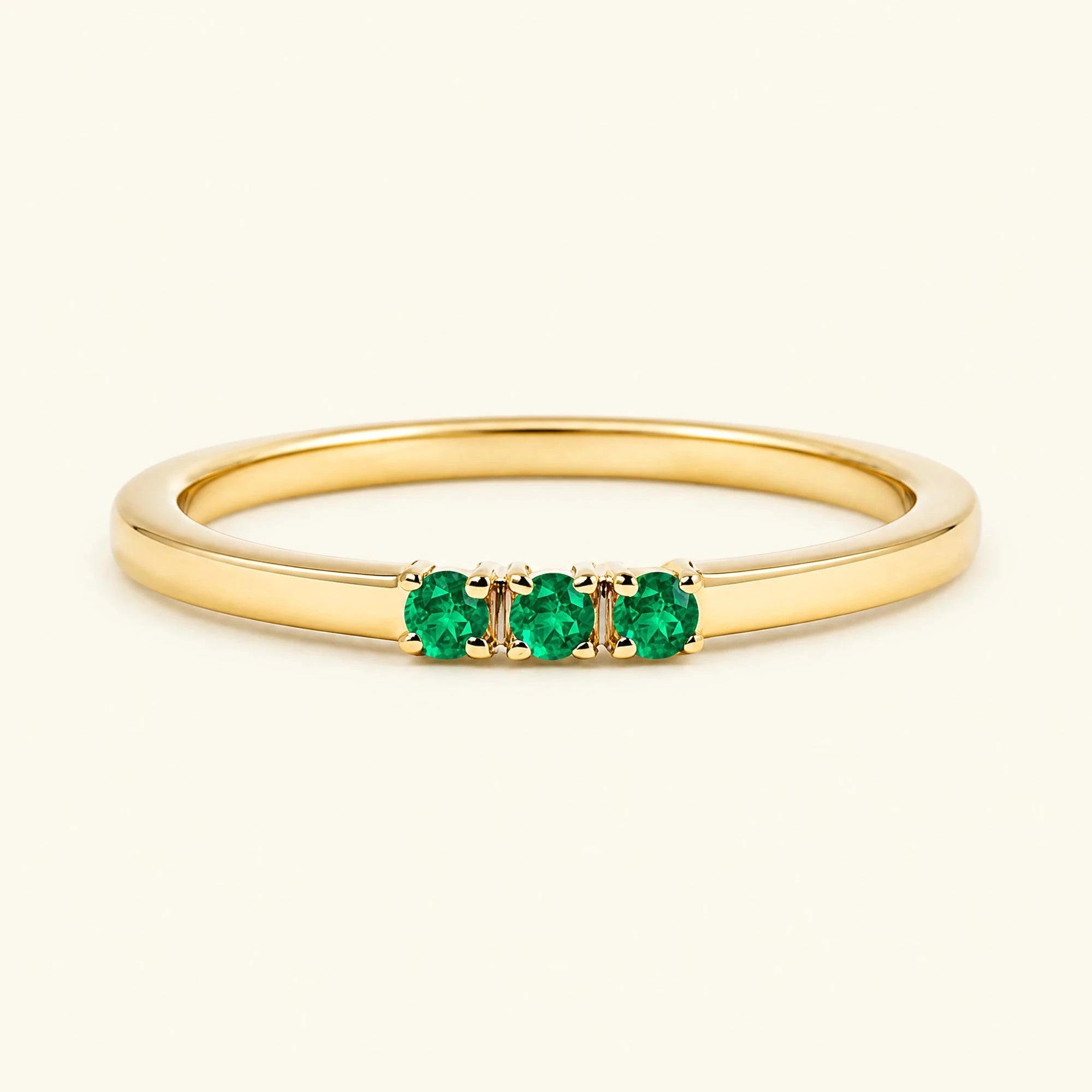 Emerald trilogy engagement ring in yellow gold