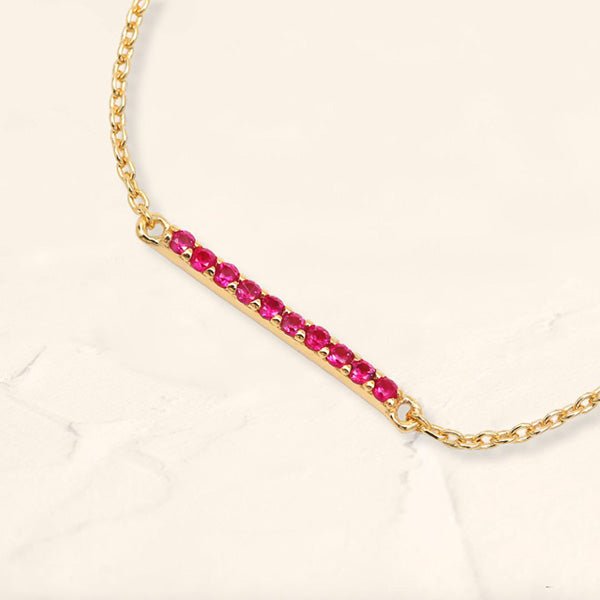 Long bar bracelet with rubies in yellow gold