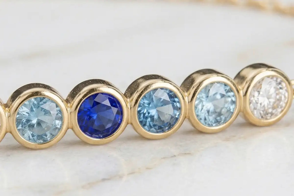 Noor Horizon Sapphire bracelet, gradient from royal blue to pure white, bezel set in 18K gold