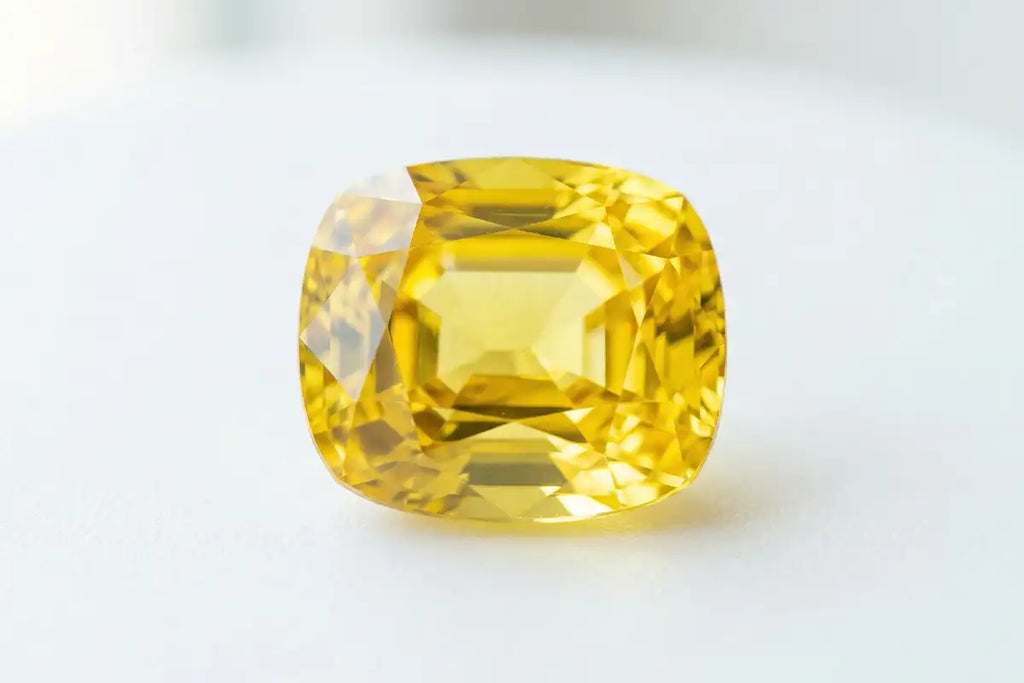 Natural cut yellow sapphire, canary colour, white background