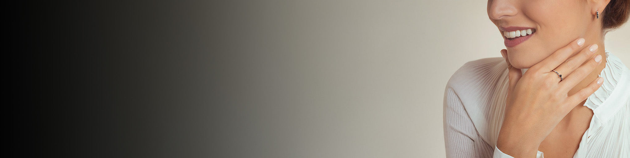 Black diamond ring set on white gold 18K worn by smiling woman, modern fine jewellery