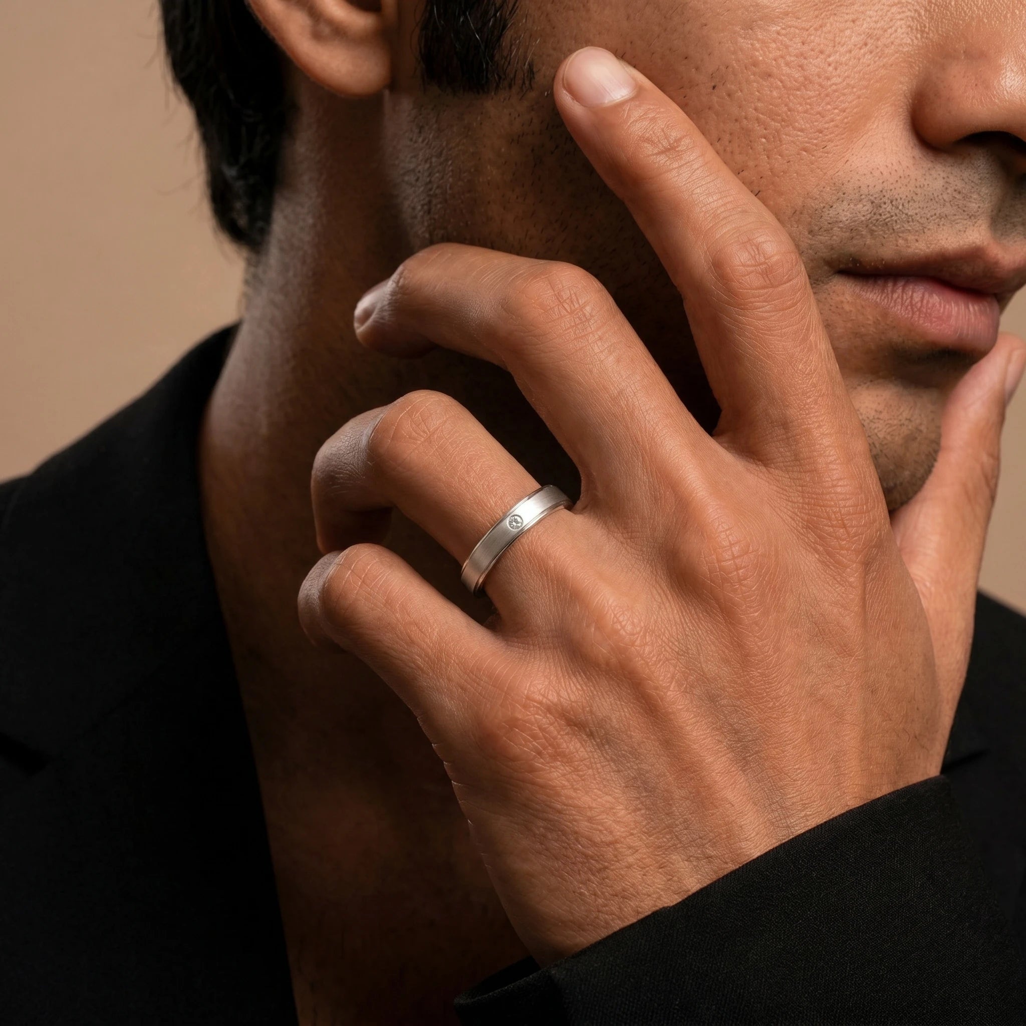 Dhruva diamond band in white gold worn by a man, brushed band