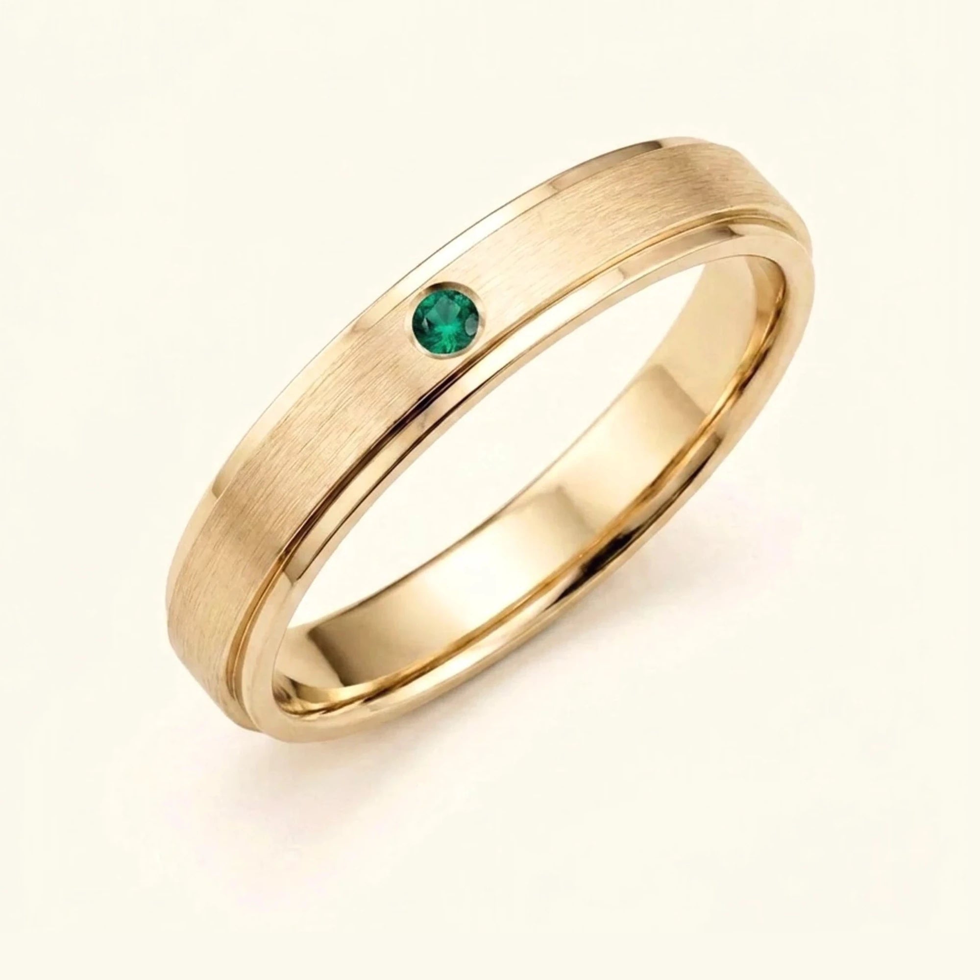 Dhruva emerald wedding band in 18k yellow gold, brushed band bezel setting