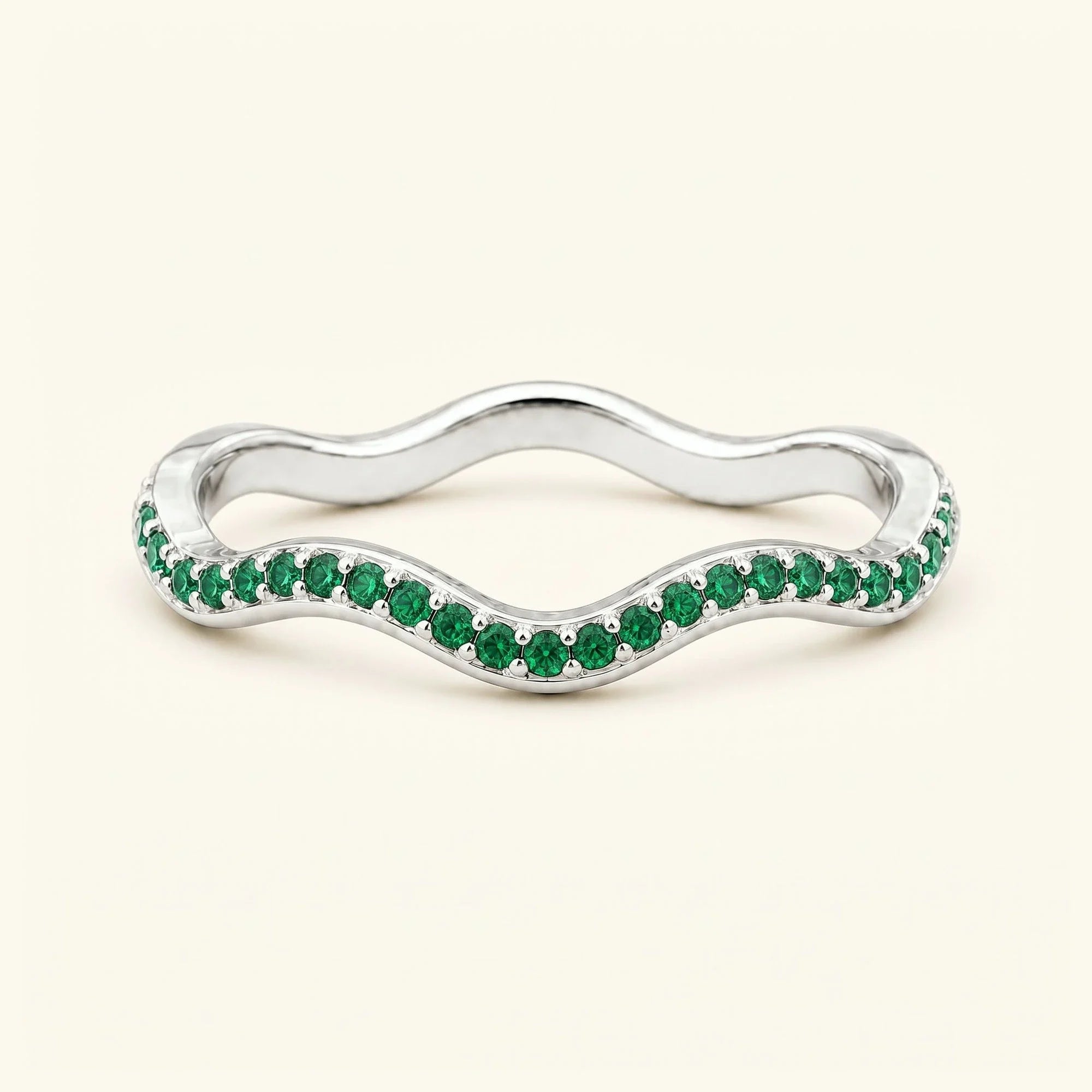 Thalassa wave wedding ring with emeralds in 18K white gold, half-eternity pavé set