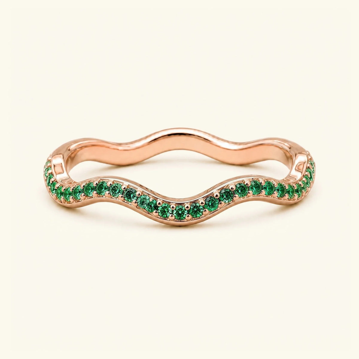 Thalassa wave wedding ring with emeralds in 18K rose gold, half-eternity pavé set