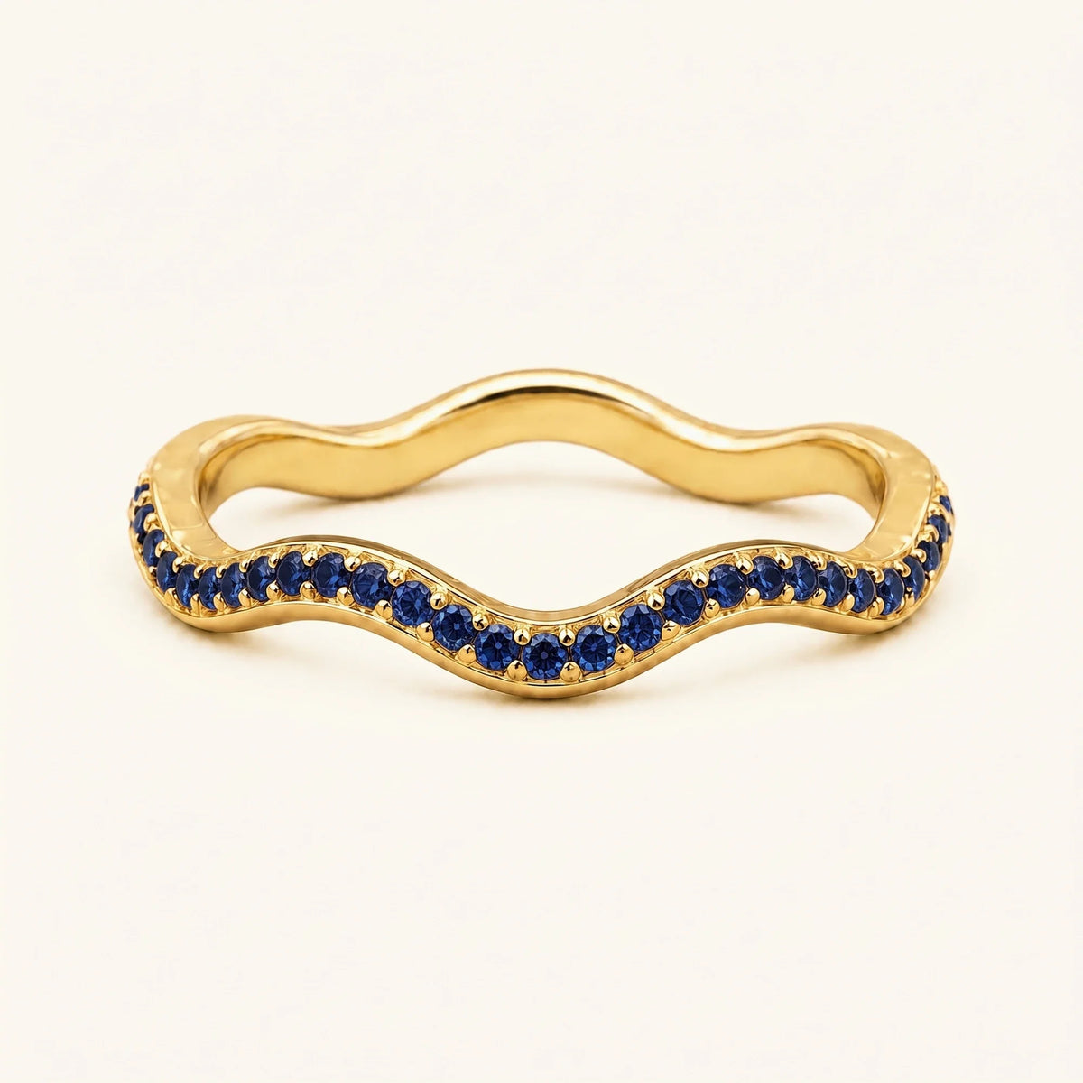 Thalassa wave wedding ring with sapphires in 18K yellow gold, half-eternity pavé set