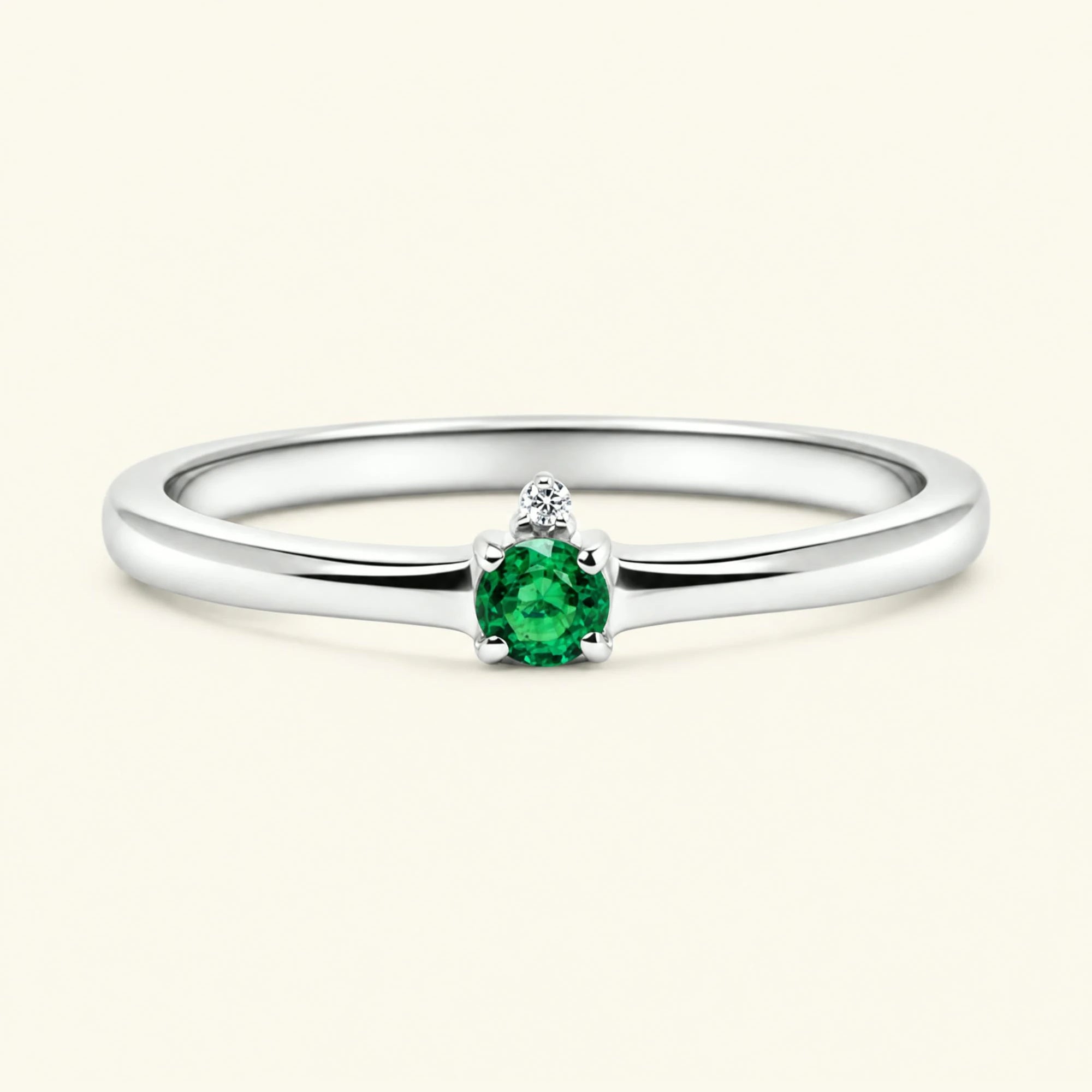 Emerald solitaire engagement ring in white gold