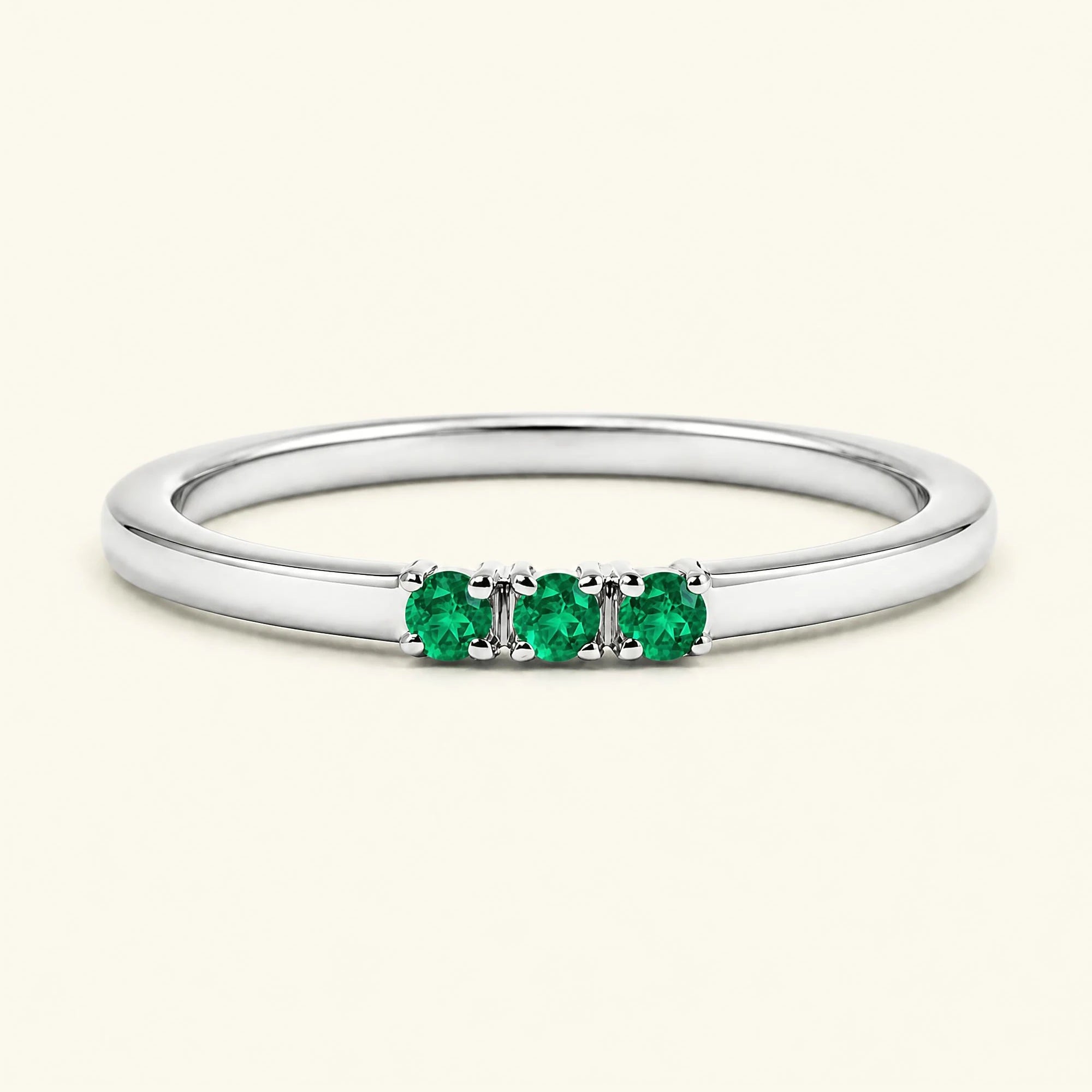 Emerald trilogy engagement ring in white gold