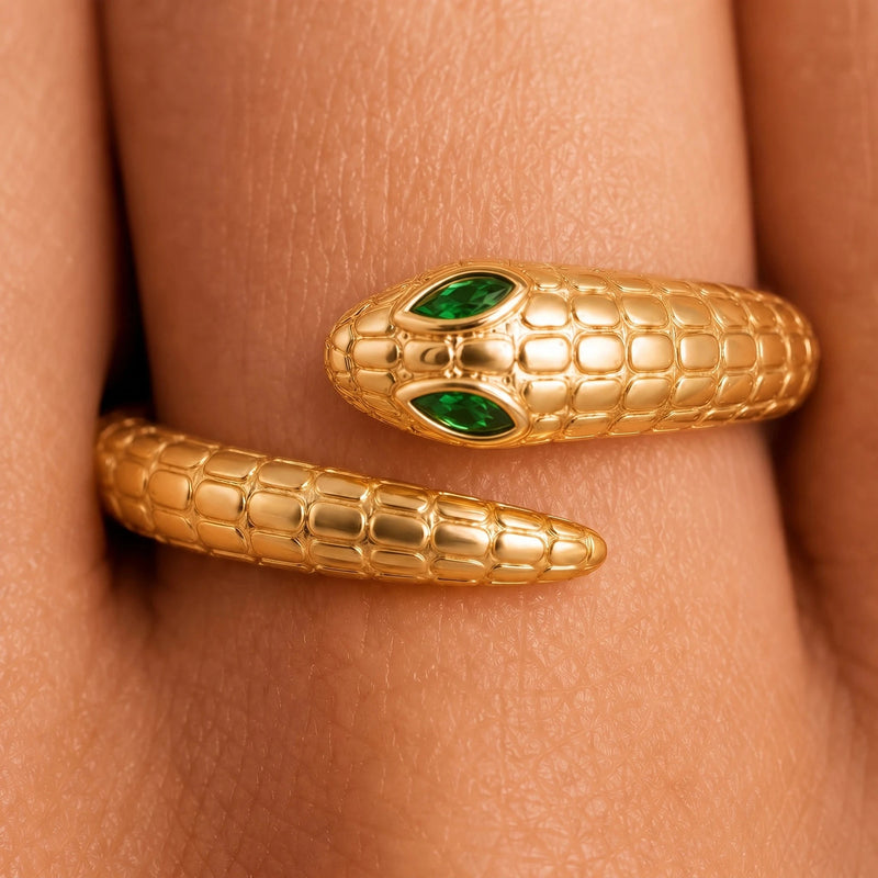 Close-up of the marquise emerald eyes of the Mehen snake ring in 18K yellow gold