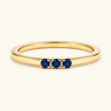 Sapphire trilogy engagement ring in yellow gold