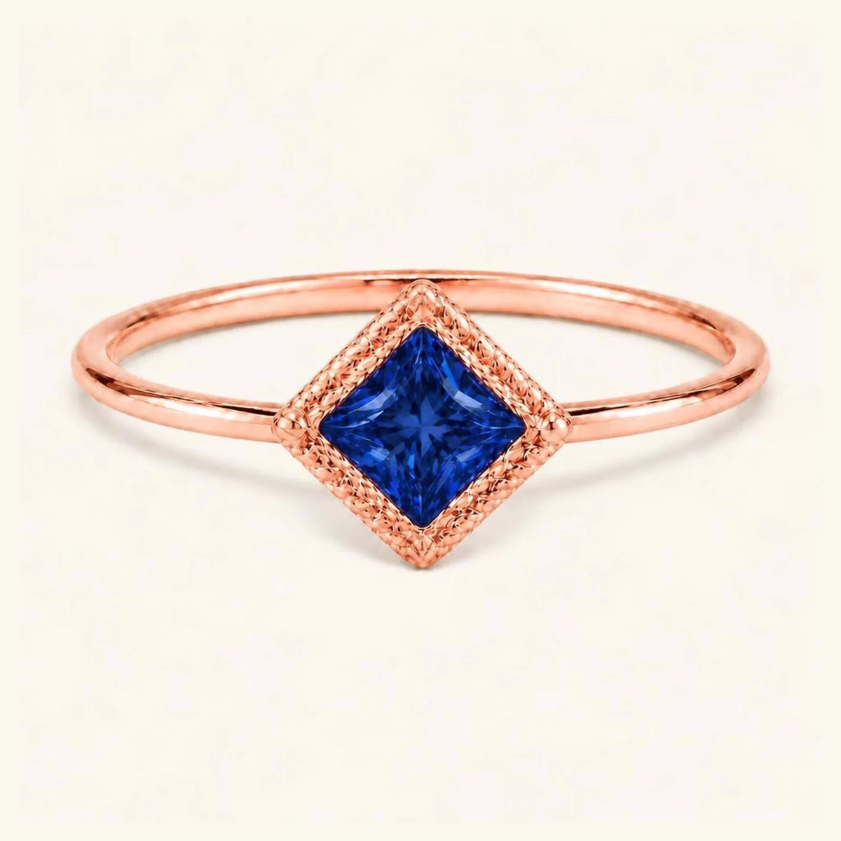 Vintage Indrani engagement ring — sapphire solitaire princess cut 4 mm, square stone in twisted rope setting, 18K rose gold