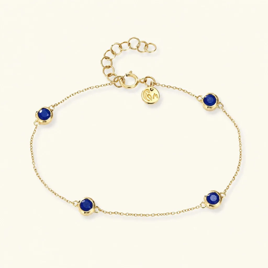 Dhanya bracelet in 18ct yellow gold with four rub-over set sapphires, a bridesmaid gift