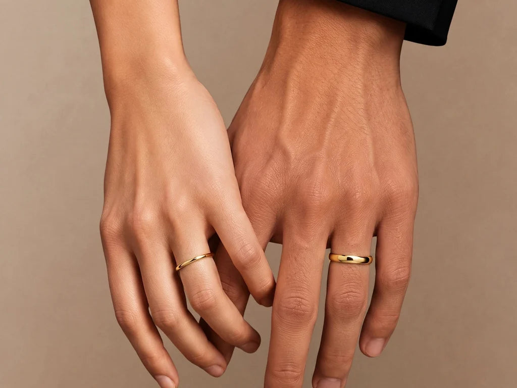 Shunya couple wedding rings in 18ct yellow gold, worn on a woman's hand and a man's hand