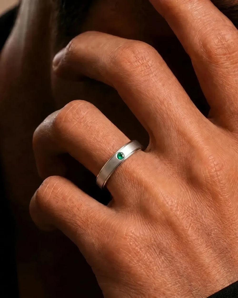 18K white gold bangle set with emerald worn on finger by Mayuri
