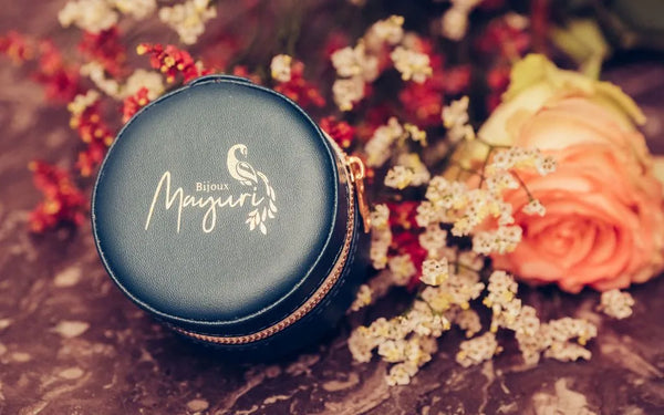 Mayuri round turquoise velvet case with fine jewellery on lifestyle floral background