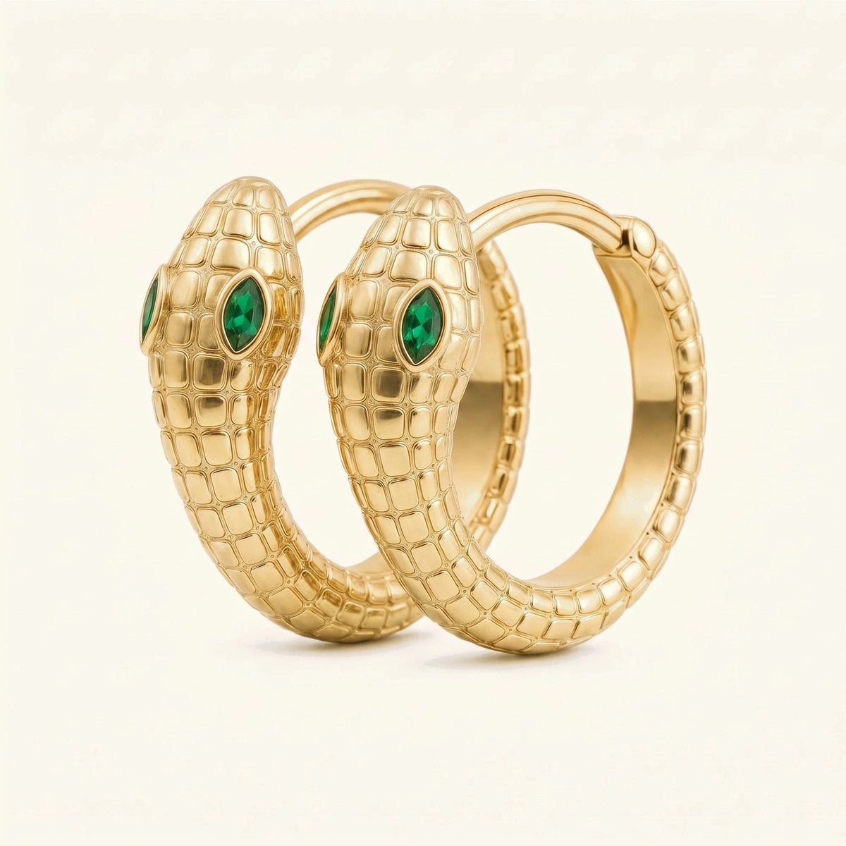 Mehen snake hoop earrings in 18K yellow gold, scaled body coiled into a hoop and marquise emerald eyes