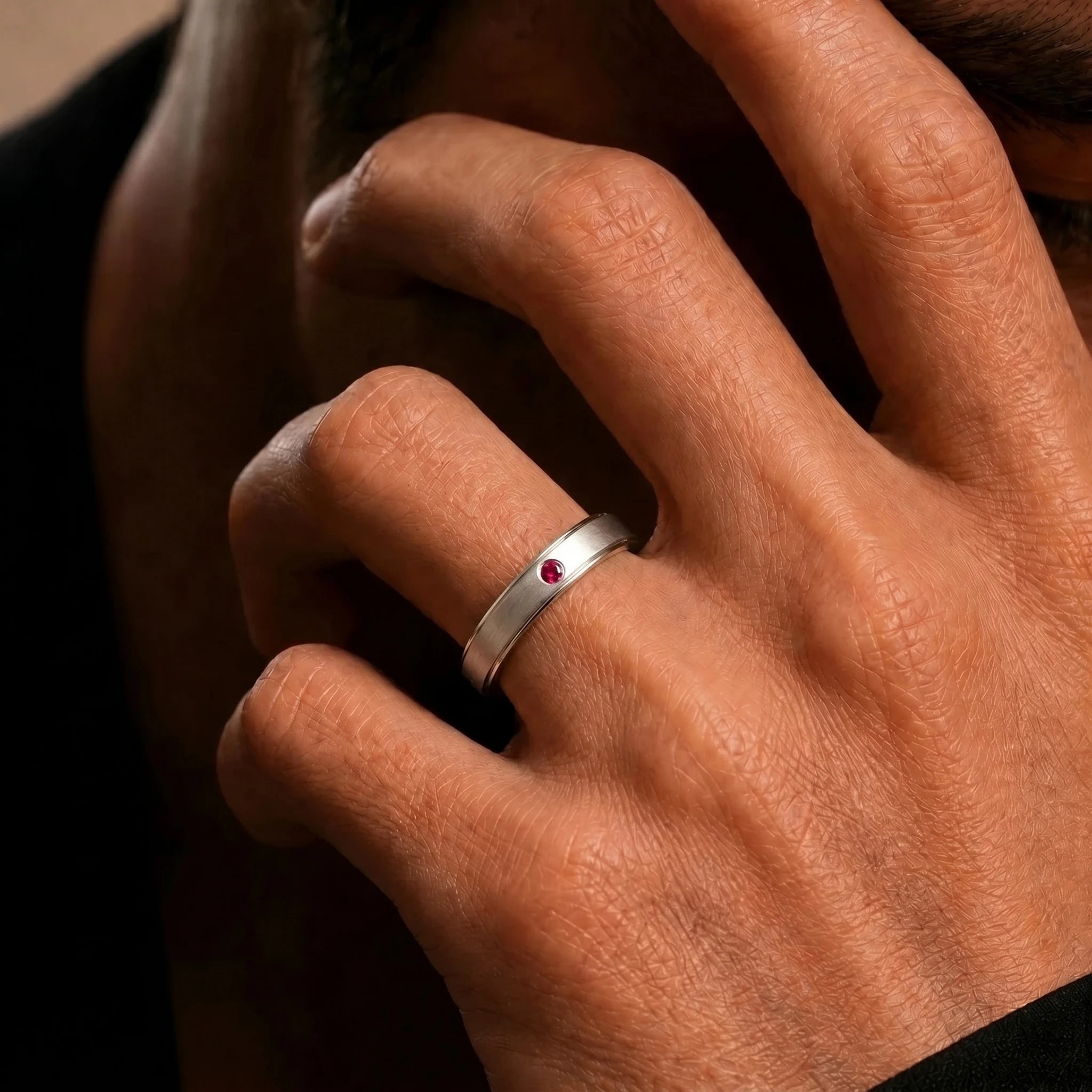 Dhruva ruby band in white gold worn on the finger, brushed band