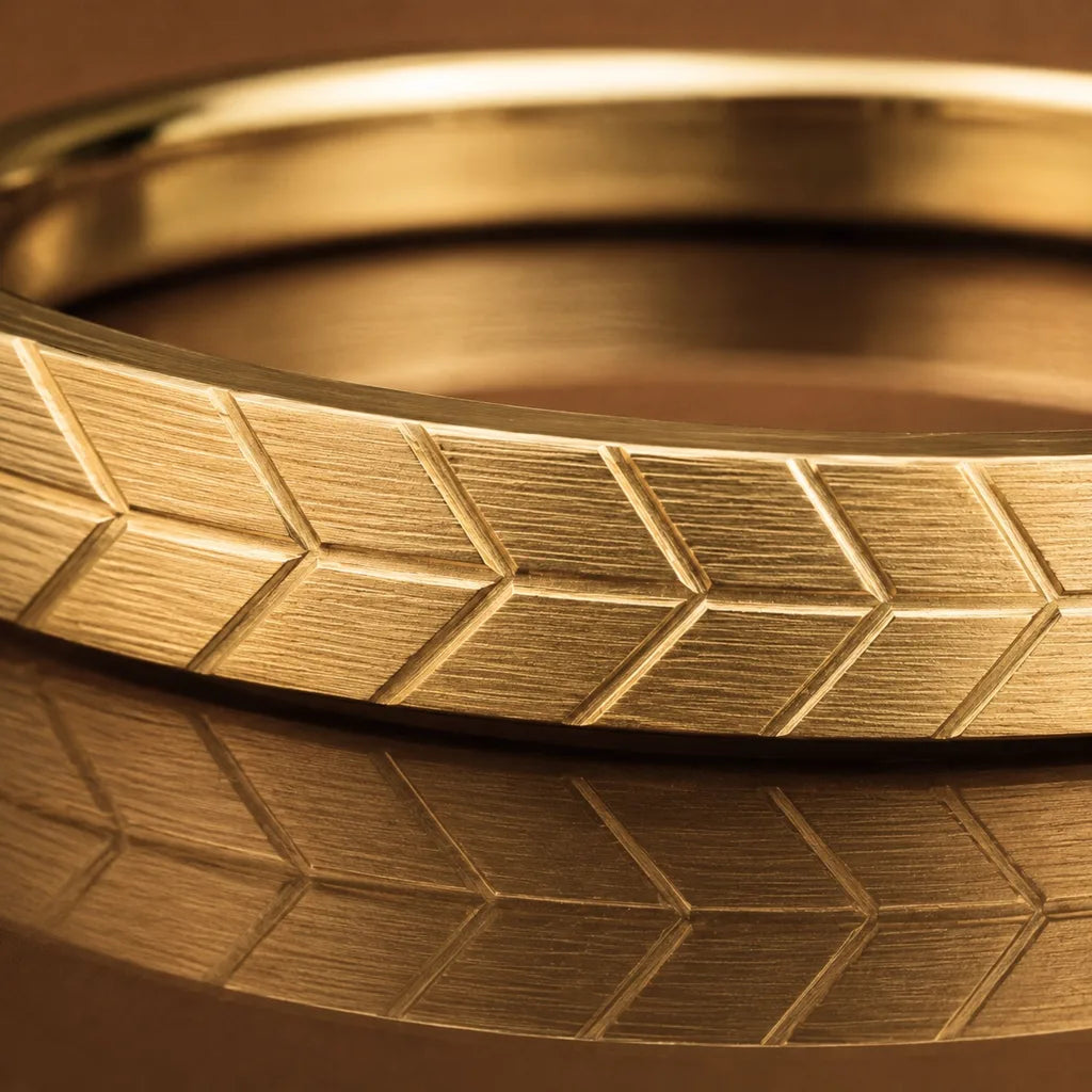 The Maat wedding ring in 18ct yellow gold with detailed chevron engraving, showcasing the precision of Mayuri's precious metalwork